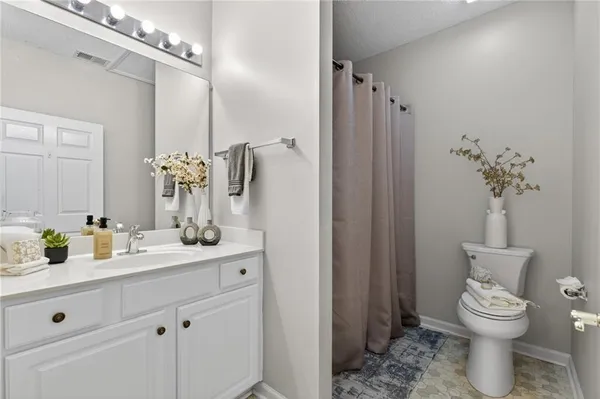 a bathroom with a toilet sink and shower