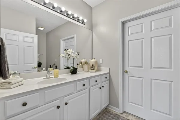 a bathroom with a double vanity sink and a mirror