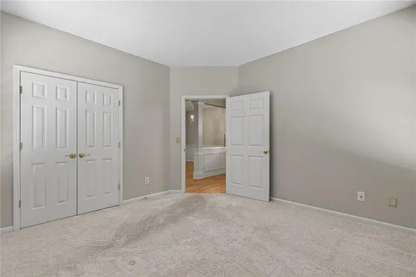 a view of an empty room with closet area