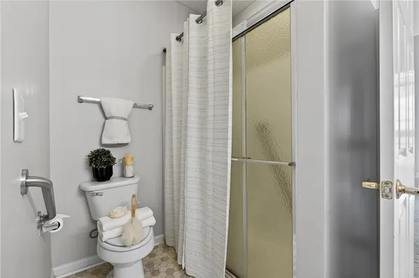 a bathroom with a toilet and a shower