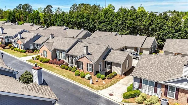 an aerial view of a house with large trees
