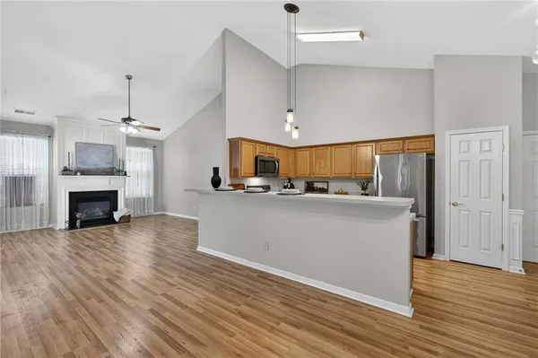 a view of a kitchen with furniture and wooden floor