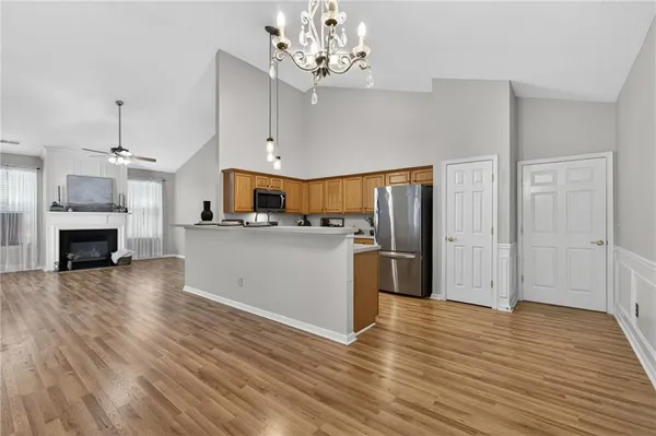 a view of a kitchen with a sink and a refrigerator