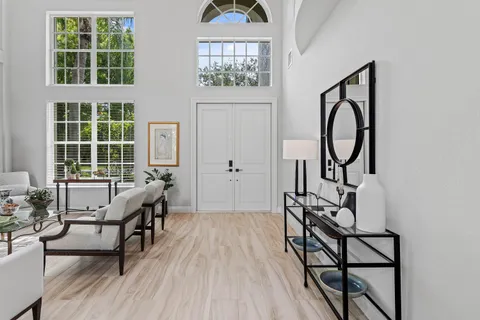 a living room with furniture a window and wooden floor