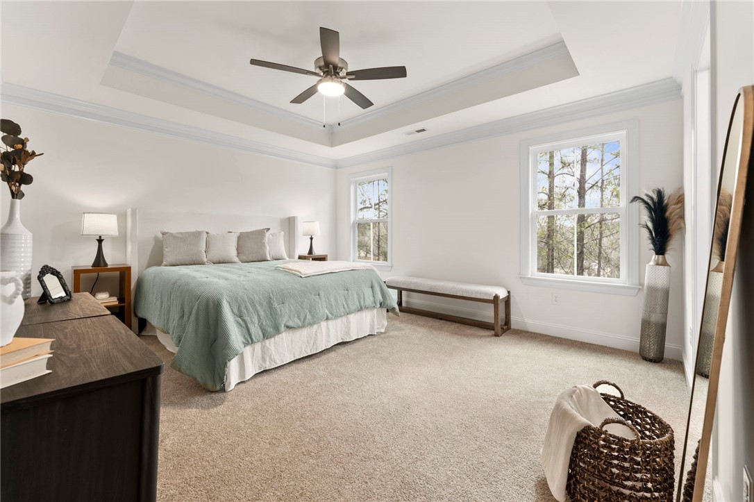 505 Fire Tower Road Williamston, SC 29697 - Photo 20 of 37 This spacious bedroom offers high ceilings and a serene atmosphere, perfect for relaxation.