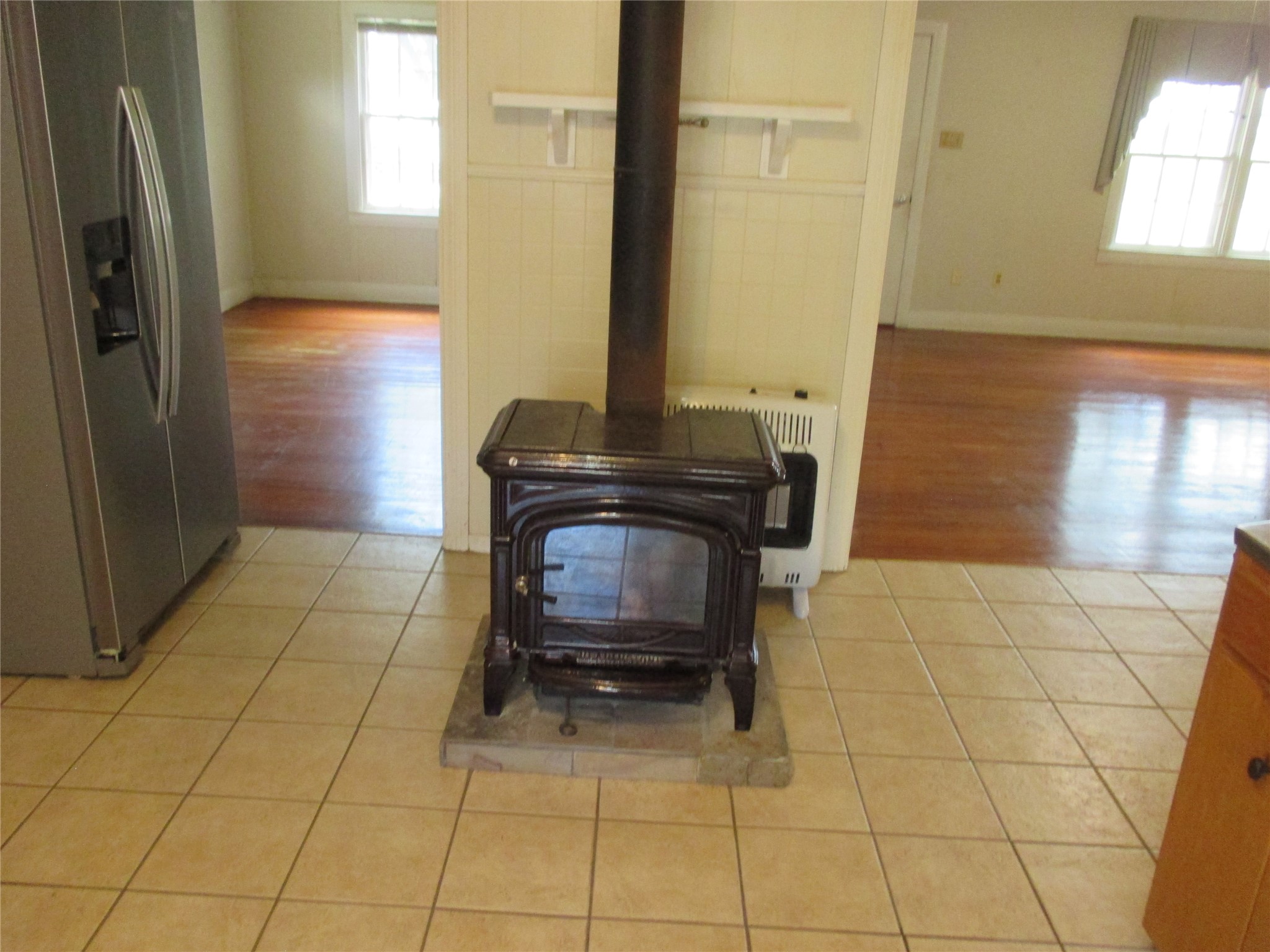 12610 Pecan School Road Bartlett, TX 76511 - Photo 9 of 21 A freestanding wood stove creates a focal point in this kitchen area.
