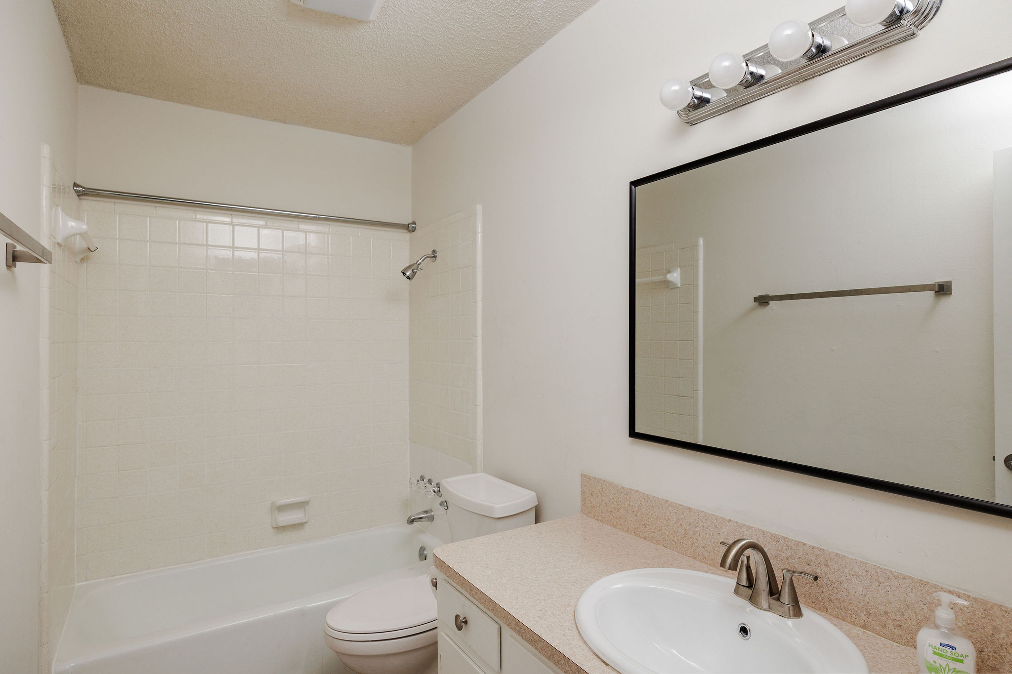 2012 Cody Court Austin, TX 78704 - Photo 29 of 40 A well-appointed bathroom with a spacious vanity, large mirror, and tiled shower-tub combination.