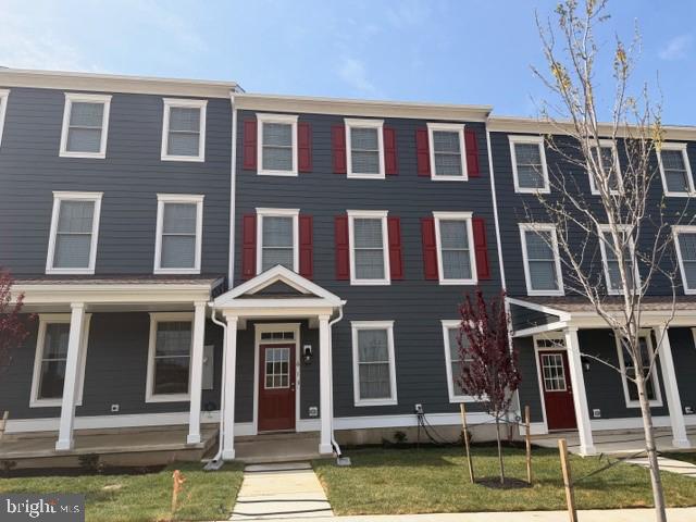 a front view of a residential apartment building with a yard
