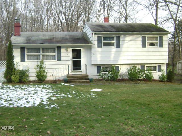 4 Woodlawn Road Monroe, CT 06468 - Photo 1 of 1 a front view of a house with a garden