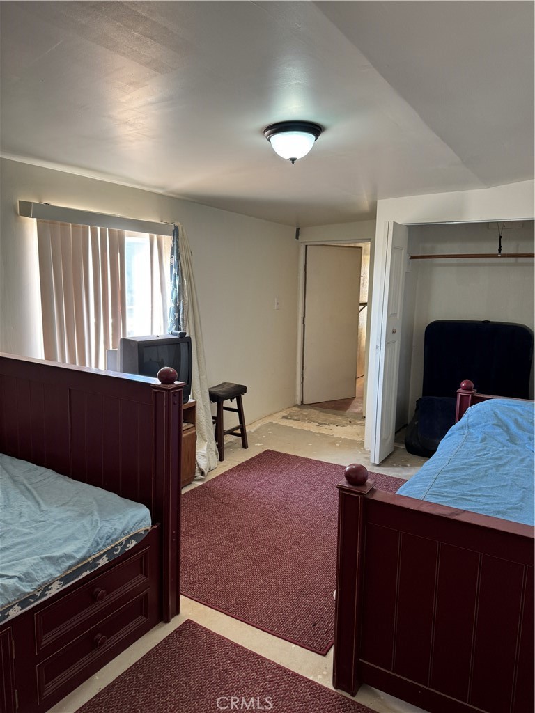 3110 Wilson Road Twentynine Palms, CA 92277 - Photo 13 of 34 a bedroom with a bed and a fireplace