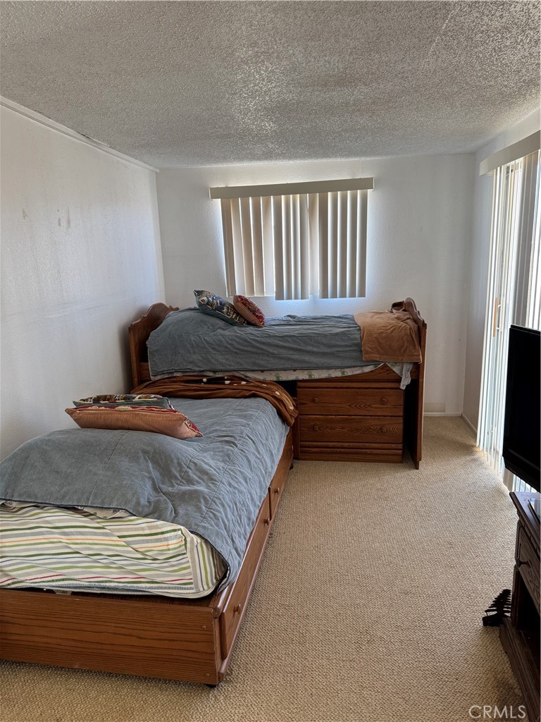 3110 Wilson Road Twentynine Palms, CA 92277 - Photo 27 of 34 a bedroom with a bed and a flat screen tv
