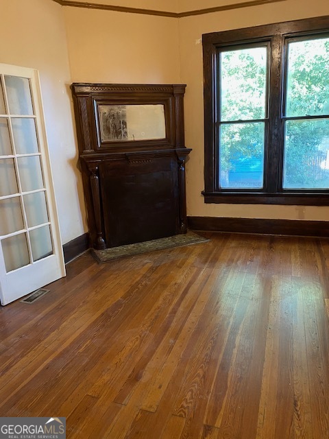 252 Edwards Street Elberton, GA 30635 - Photo 17 of 43 a view of an empty room with wooden floor and a window