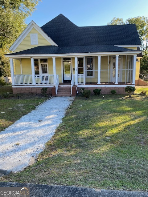 252 Edwards Street Elberton, GA 30635 - Photo 3 of 43 a front view of a house with garden