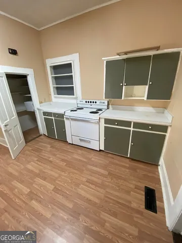 a room with a bed and a television