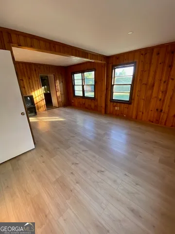 wooden floor in an empty room with a window
