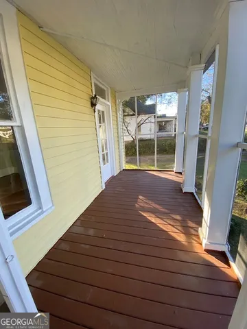 a view of a balcony with wooden floor and stairs