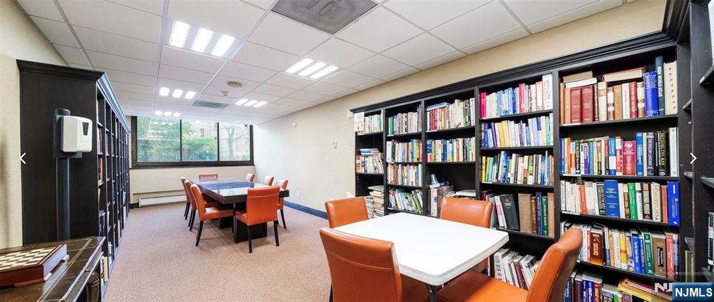 250 Gorge Road, Unit 18K Cliffside Park, NJ 07010 - Photo 27 of 30 a living room with furniture a bookshelf and a book shelf