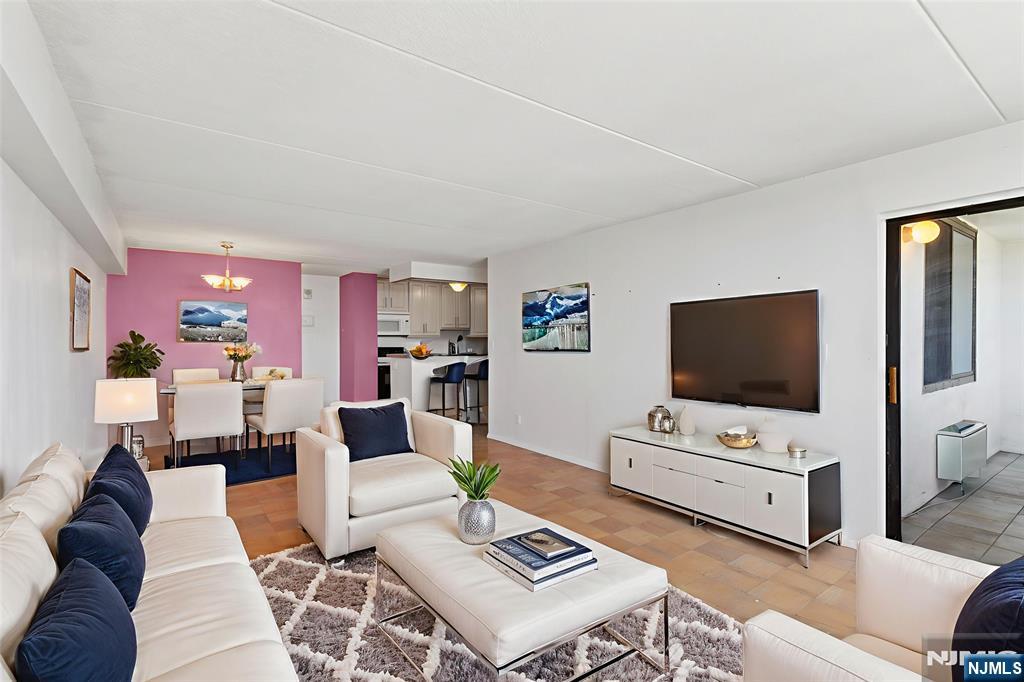 250 Gorge Road, Unit 18K Cliffside Park, NJ 07010 - Photo 3 of 30 a living room with furniture and a flat screen tv