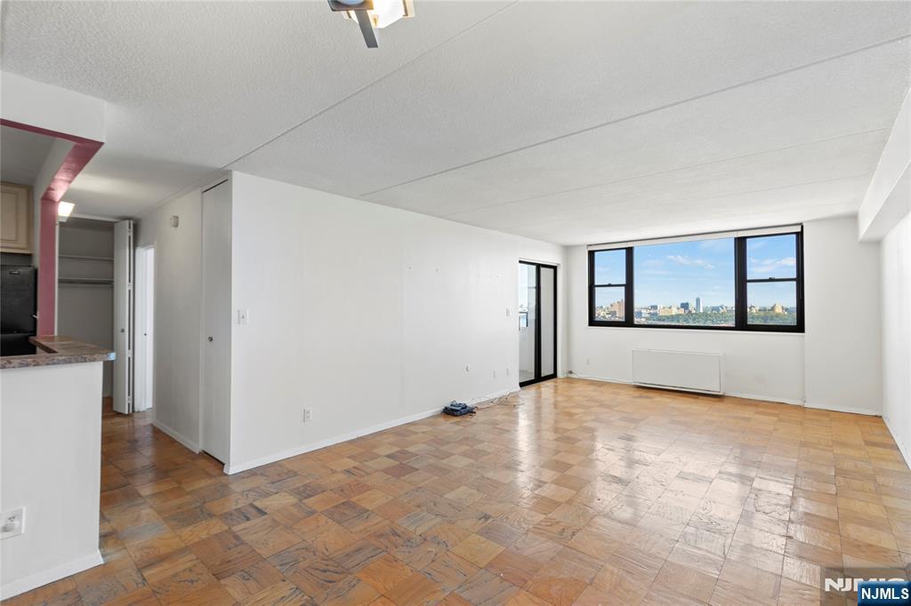 250 Gorge Road, Unit 18K Cliffside Park, NJ 07010 - Photo 5 of 30 a view of an empty room with a window and a kitchen