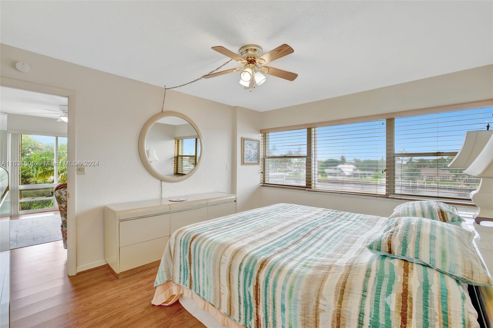 2611 North Riverside Drive, Unit 301 Pompano Beach, FL 33062 - Photo 11 of 31 a bedroom with a large bed and a large window