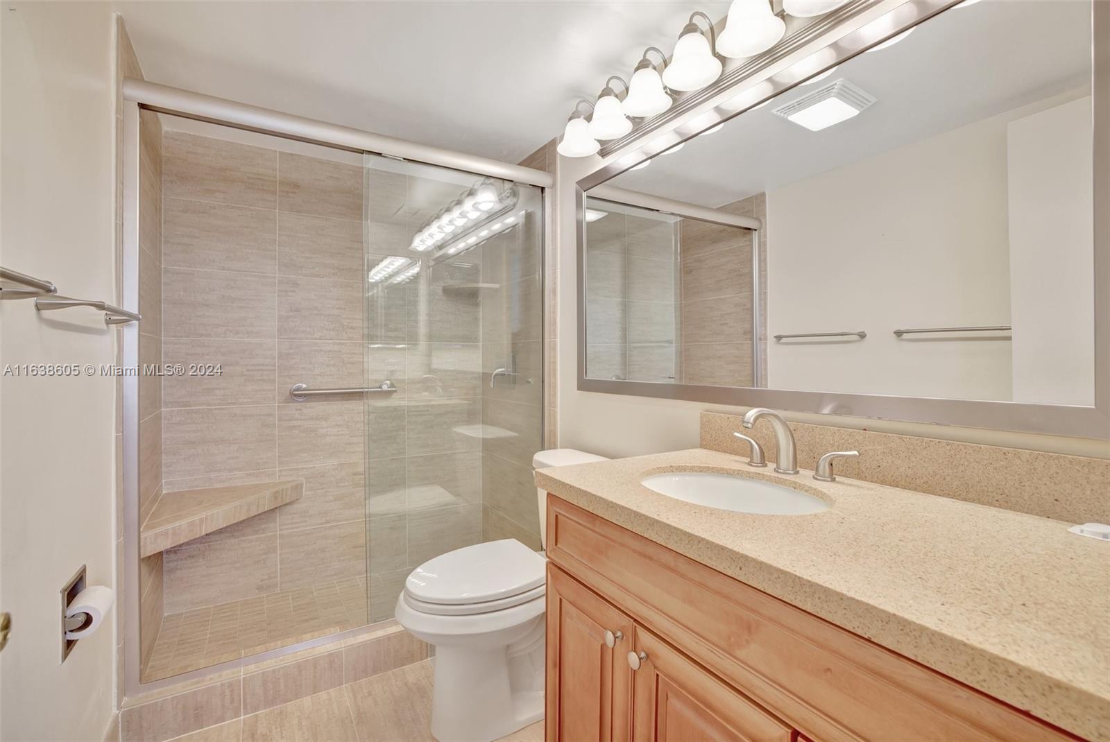 2611 North Riverside Drive, Unit 301 Pompano Beach, FL 33062 - Photo 13 of 31 a bathroom with a sink a toilet and shower