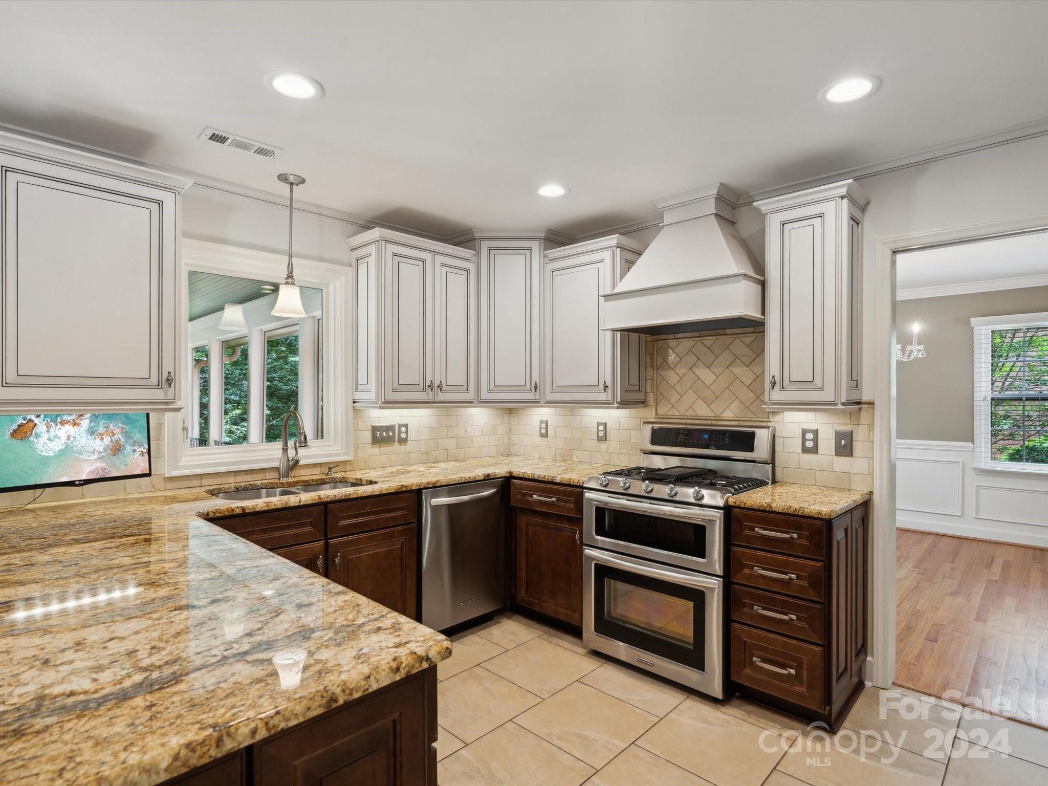 419 Neill Ridge Road Matthews, NC 28105 - Photo 8 of 41 a kitchen with stainless steel appliances granite countertop a sink stove and cabinets