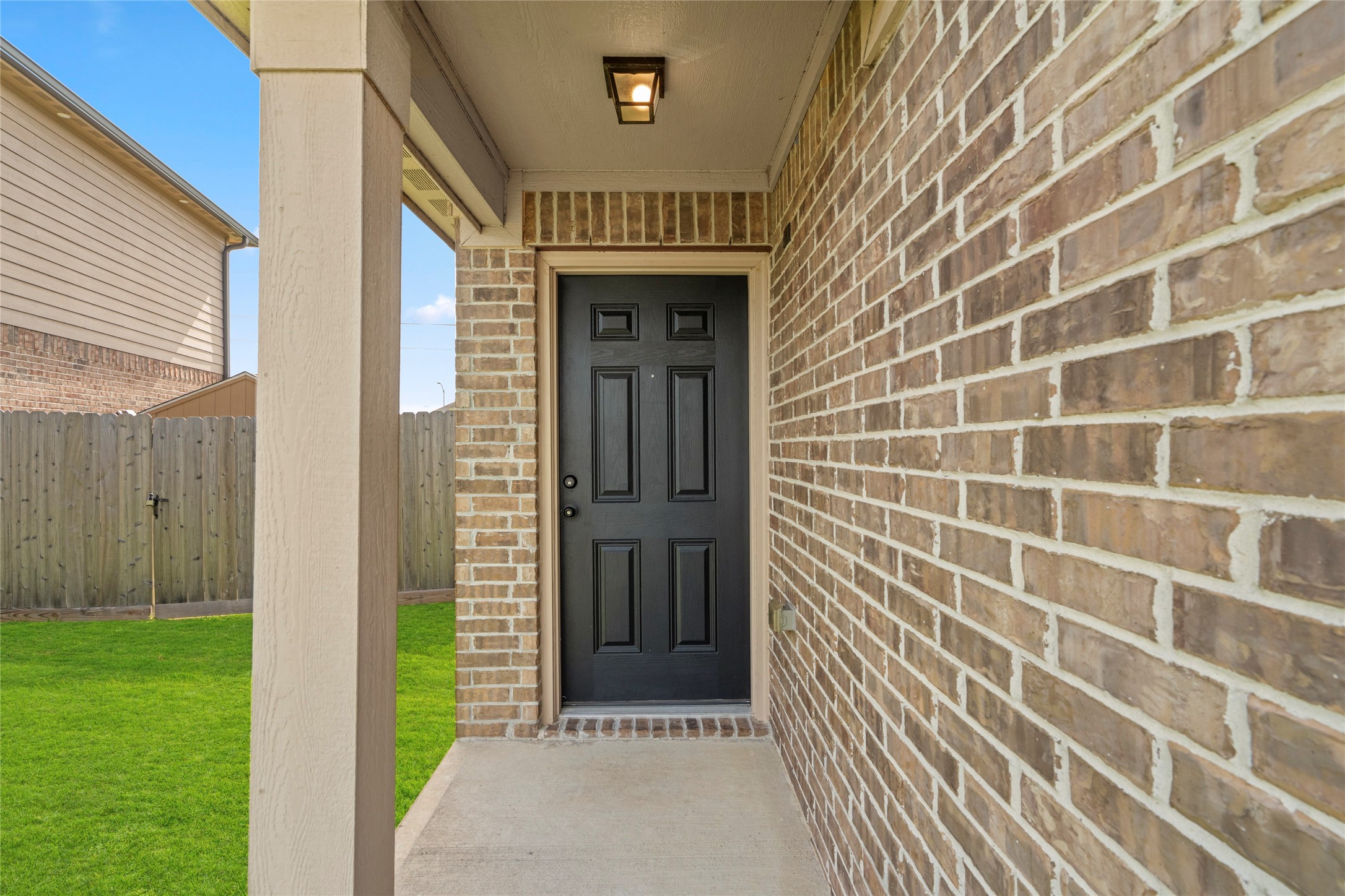 9719 Montana Sapphire Lane Rosharon, TX 77583 - Photo 3 of 40 Covered front entry with a solid front door and brick exterior detailing creating a warm arrival space.