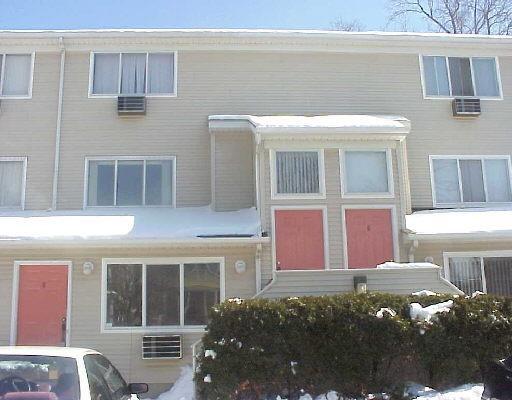 30 Elmcroft Road, Unit 5B Stamford, CT 06902 - Photo 1 of 1 a front view of a house with a yard