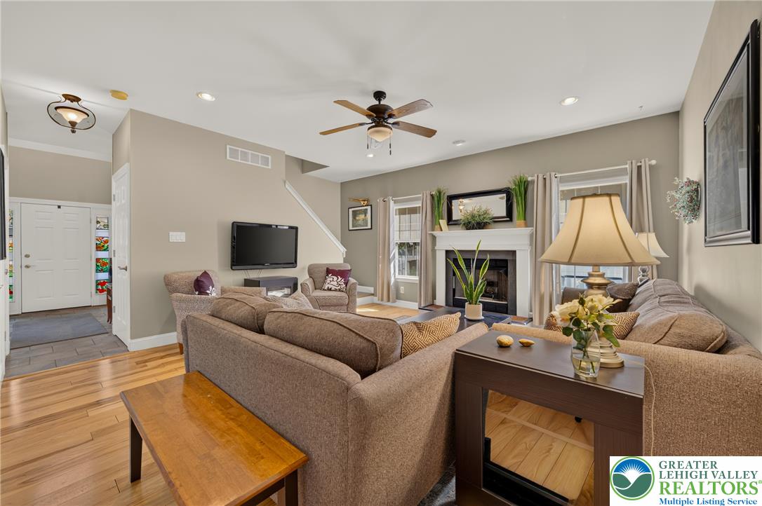 1702 Red Bud Road Quakertown, PA 18951 - Photo 20 of 68 A well-lit living area features hardwood floors and a cozy fireplace, perfect for gatherings.