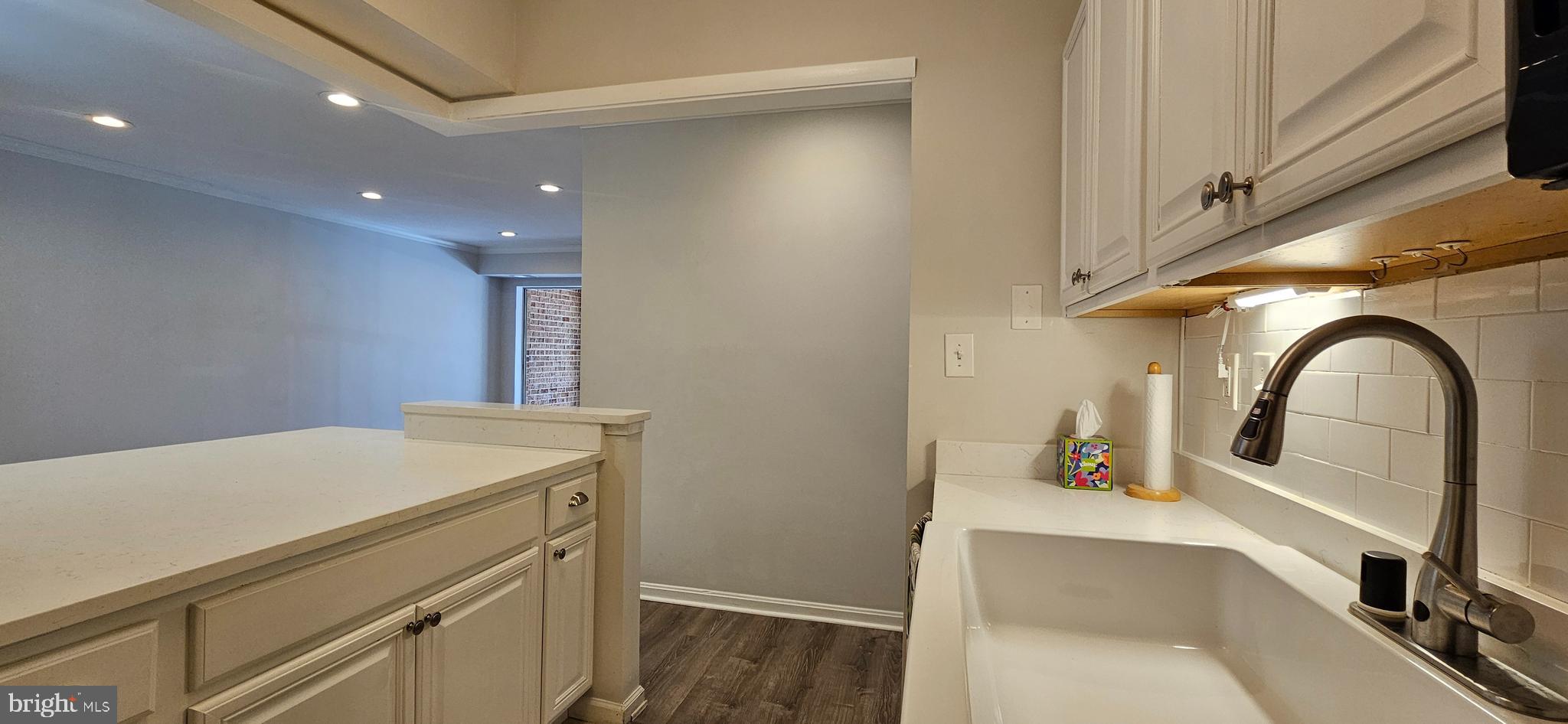 5831 Cove Landing Road, Unit 301 Burke, VA 22015 - Photo 11 of 33 a kitchen with a sink and a stove with wooden floor