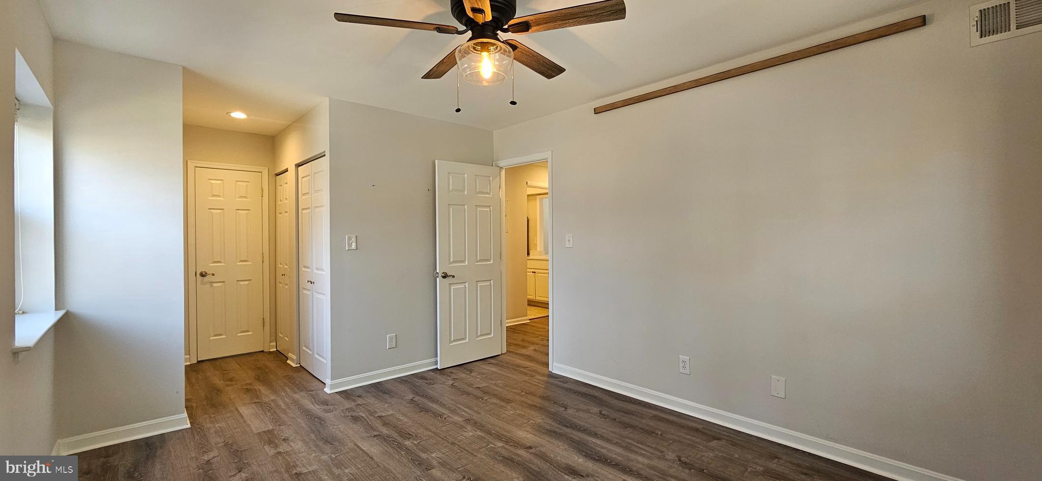 5831 Cove Landing Road, Unit 301 Burke, VA 22015 - Photo 15 of 33 a view of an empty room with window and wooden floor