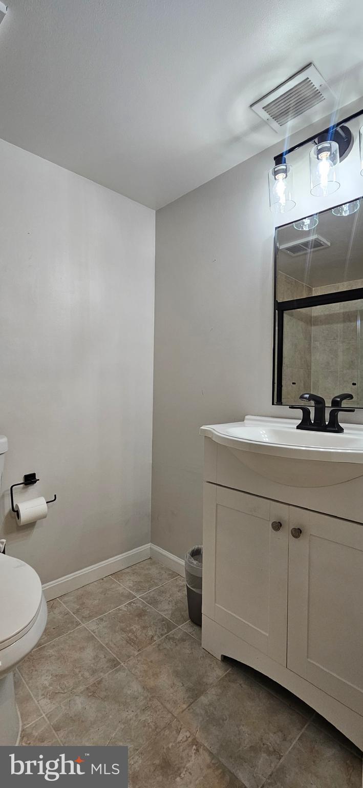 5831 Cove Landing Road, Unit 301 Burke, VA 22015 - Photo 16 of 33 a bathroom with a sink and a mirror