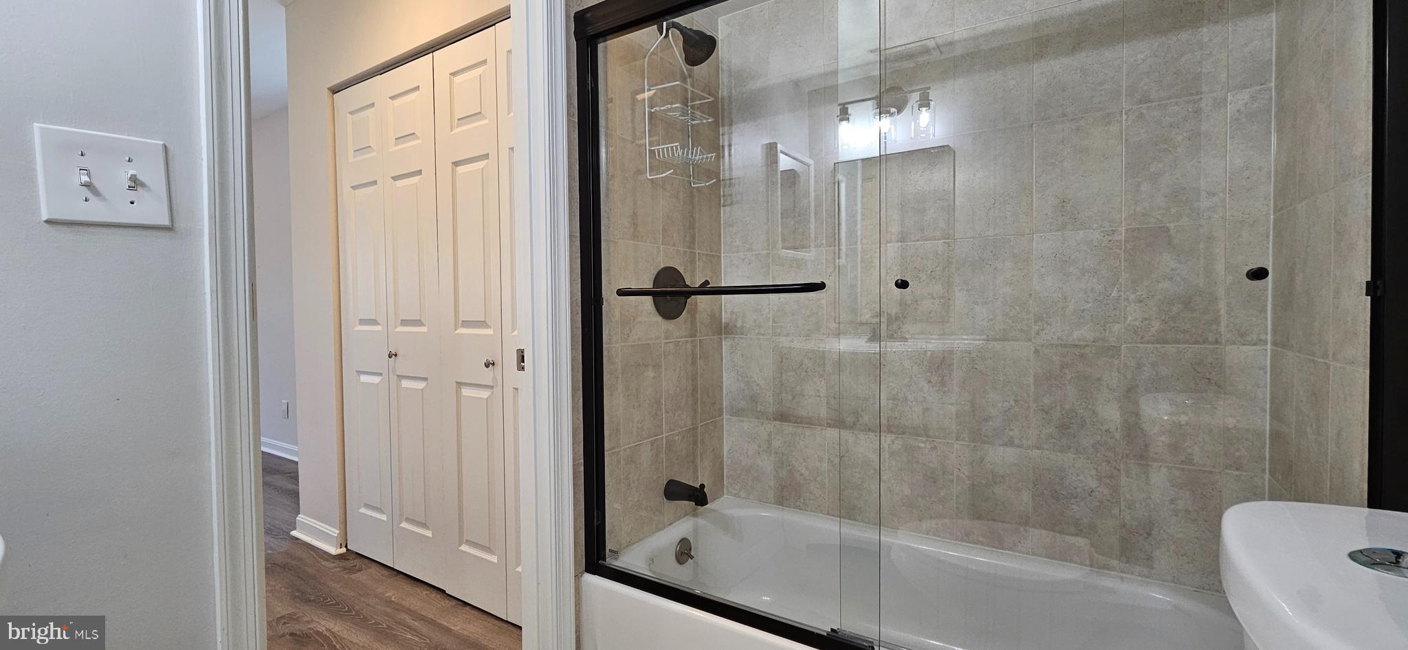 5831 Cove Landing Road, Unit 301 Burke, VA 22015 - Photo 18 of 33 a bathroom with a glass shower door
