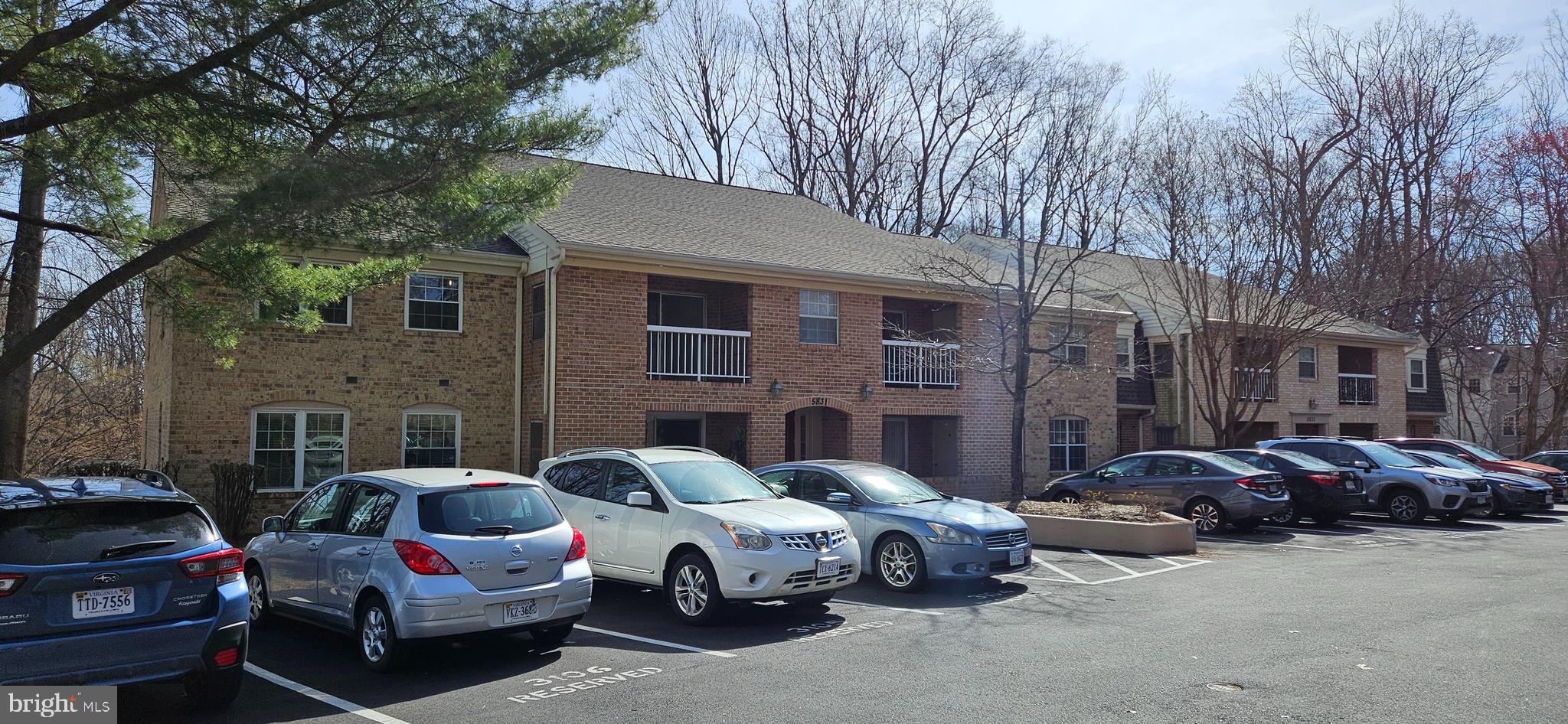 5831 Cove Landing Road, Unit 301 Burke, VA 22015 - Photo 2 of 33 a car parked in front of a brick house