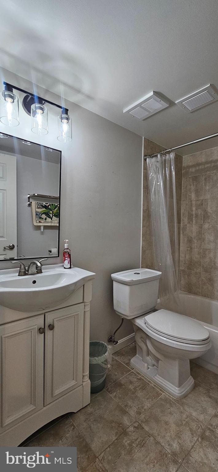 5831 Cove Landing Road, Unit 301 Burke, VA 22015 - Photo 23 of 33 a bathroom with a toilet sink and mirror