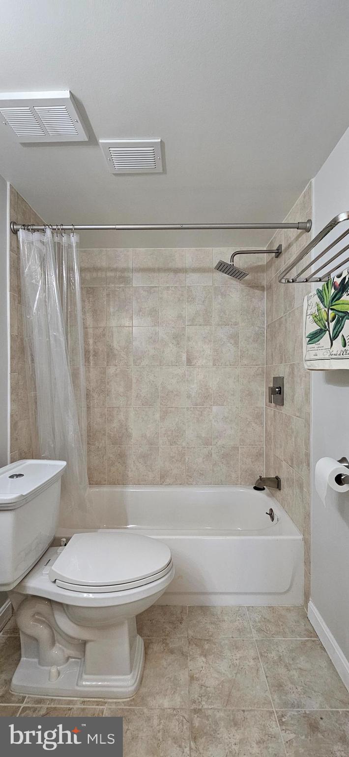 5831 Cove Landing Road, Unit 301 Burke, VA 22015 - Photo 24 of 33 a bathroom with a toilet and a shower