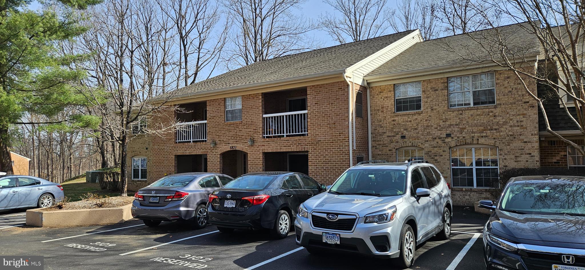 5831 Cove Landing Road, Unit 301 Burke, VA 22015 - Photo 3 of 33 a front view of a house with parking space
