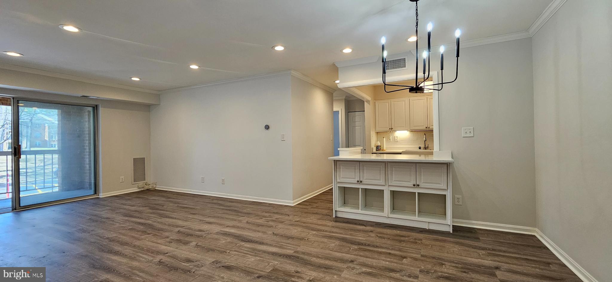 5831 Cove Landing Road, Unit 301 Burke, VA 22015 - Photo 4 of 33 an empty room with wooden floor and windows