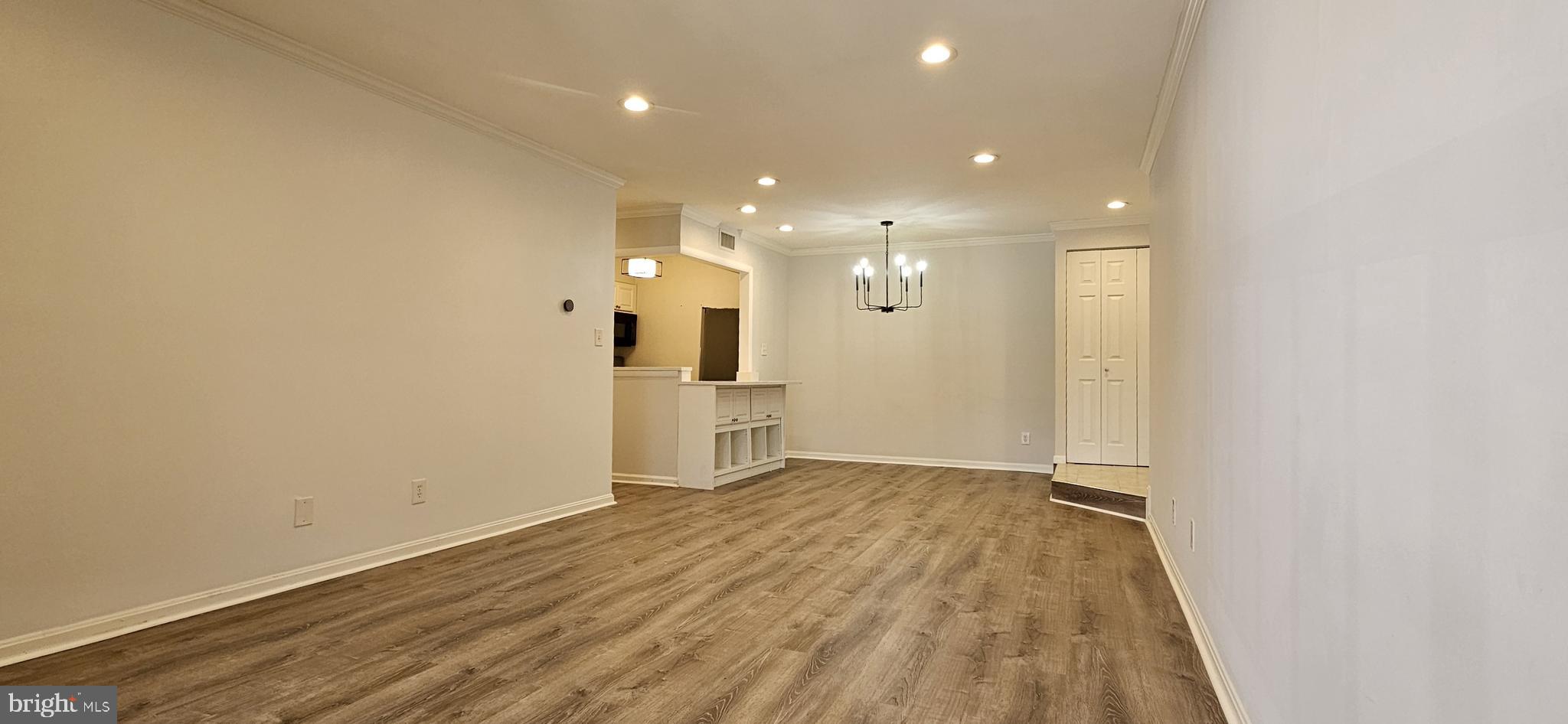 5831 Cove Landing Road, Unit 301 Burke, VA 22015 - Photo 6 of 33 a view of empty room with wooden floor