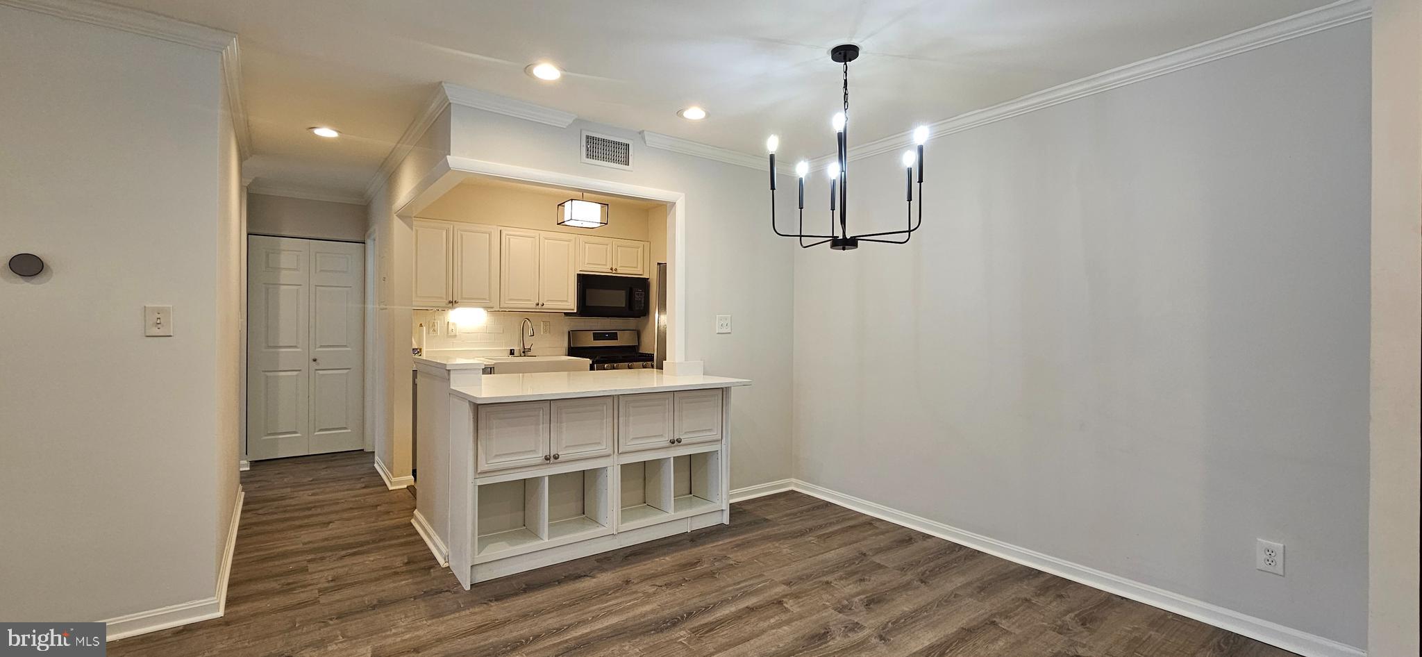 5831 Cove Landing Road, Unit 301 Burke, VA 22015 - Photo 8 of 33 a view of a kitchen from the hallway