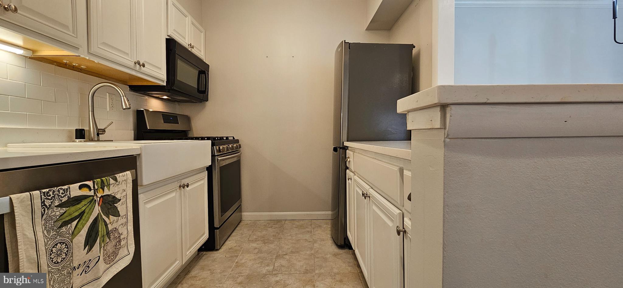 5831 Cove Landing Road, Unit 301 Burke, VA 22015 - Photo 10 of 33 a utility room with dryer and washer