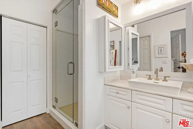 a bathroom with a shower sink and mirror