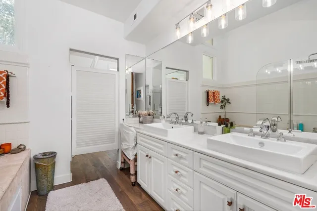 a bathroom with a sink double vanity granite and a mirror