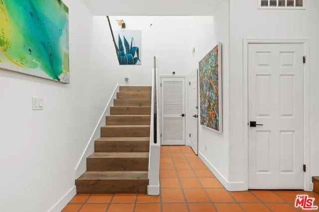 a view of entryway with wooden floor and stairs