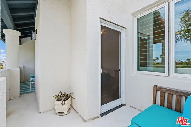 a view of hallway with furniture and a potted plant