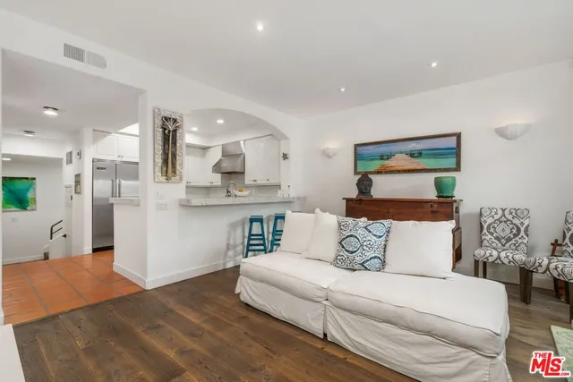 a living room with furniture and kitchen view