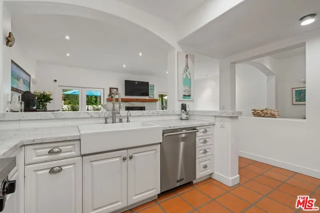 a kitchen with cabinets appliances a sink and a counter top space
