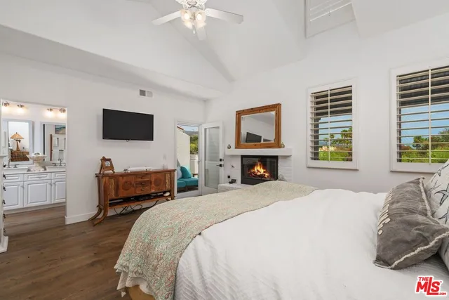 a large bedroom with a bed and a flat screen tv