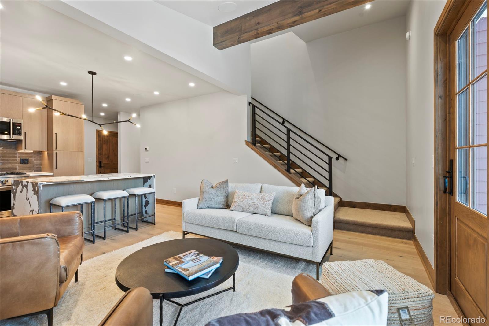 203 North Ridge Street, Unit B Breckenridge, CO 80424 - Photo 19 of 41 a living room with furniture and a dining table with wooden floor