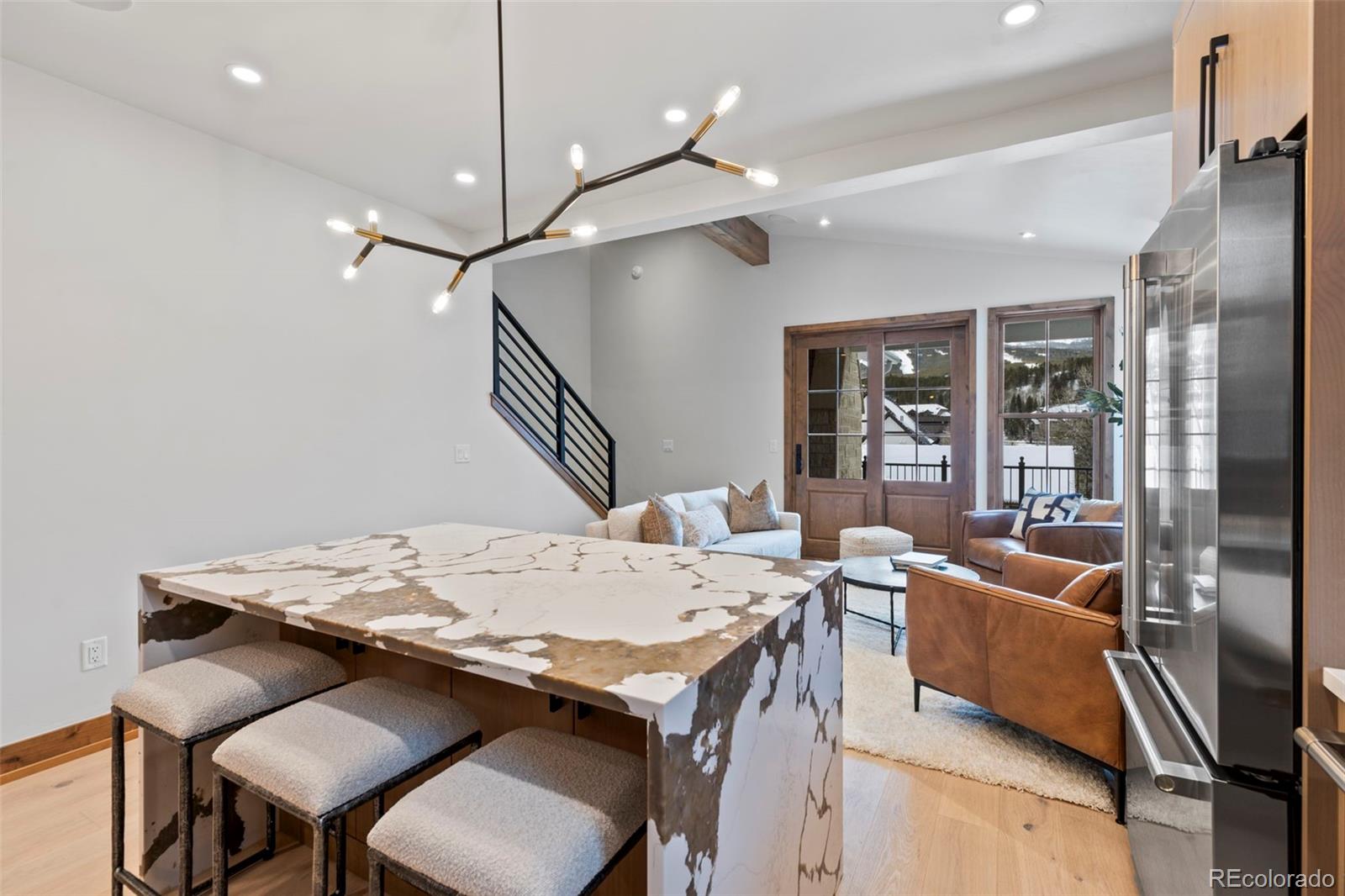 203 North Ridge Street, Unit B Breckenridge, CO 80424 - Photo 23 of 41 a view of a dining room with furniture wooden floor and chandelier